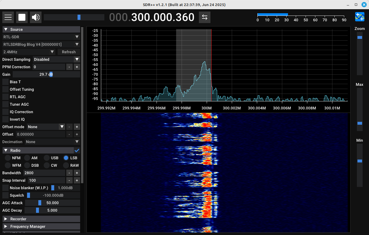 Screenshot of a software defined radio showing a spectral trace on top and a spectrogram on the bottom. The trace and spectrogram show a lower sideband amplitude modulated signal. Along the left is a column showing various parameters of the SDR, including the gain, the demodulator, and a section for recording the signal.